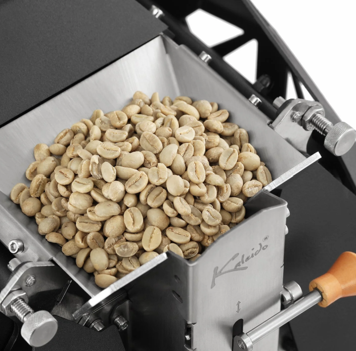 Green coffee beans loaded into the hopper before roasting